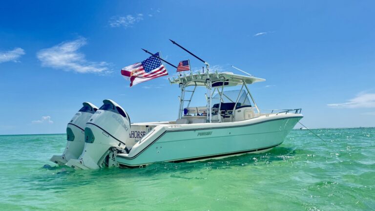A white motorboat with twin engines