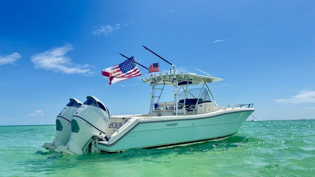 A white motorboat with two outboard engines